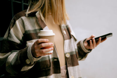 Woman holding coffee cup