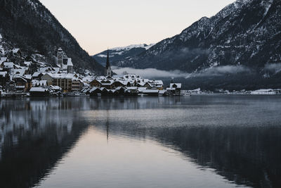 Scenic view of lake and mountains against sky during winter