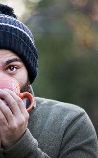 Close-up portrait of a man drinking glass