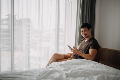 Side view of man with smart phone