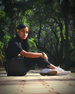 Young woman looking at camera in forest