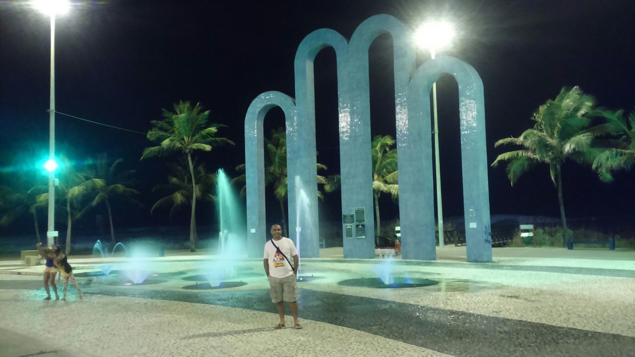 fountain, illuminated, night, sculpture, motion, statue, blue, long exposure, art and craft, art, built structure, street light, spraying, human representation, architecture, creativity, architectural column, sunlight, lighting equipment, outdoors