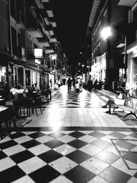 People sitting in illuminated city at night