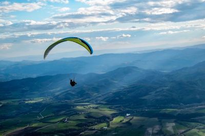 Scenic view of person paragliding against sky