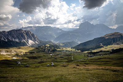 Scenic view of field and mountains against sky