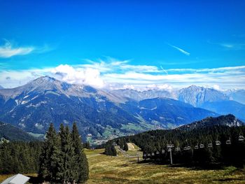 Scenic view of snowcapped mountains against blue sky