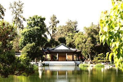 Building by lake against sky