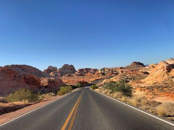 Road amidst landscape against clear sky