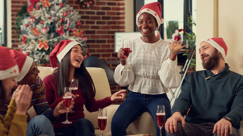 Portrait of smiling friends with friend in party