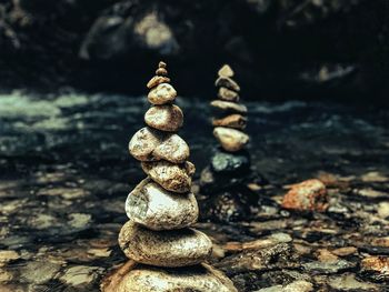 Close-up of stacked stones in lake