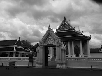 Low angle view of building against cloudy sky