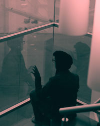 Man looking through glass window