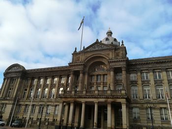 Low angle view of building against cloudy sky