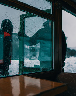 Reflection of man on glass window