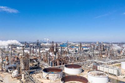 High angle view of factory against blue sky