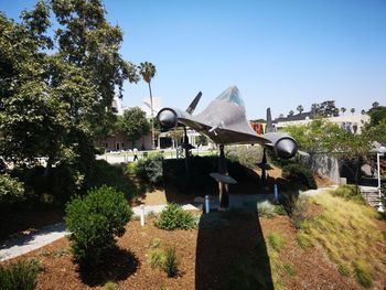 Built structure against trees and plants against sky