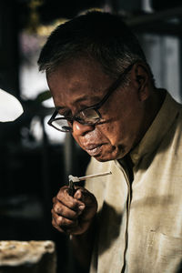 Close-up portrait of man smoking cigarette