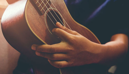 Close-up of hands playing guitar