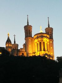 Low angle view of illuminated building against clear sky