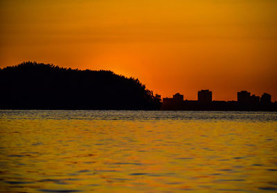 Scenic view of sea against orange sky