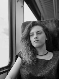 Portrait of beautiful woman sitting in bus