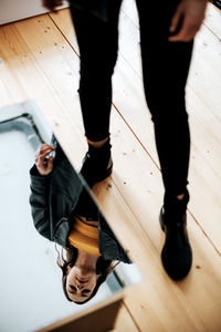 Low section of people walking on tiled floor