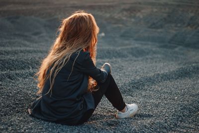 Woman sitting on road