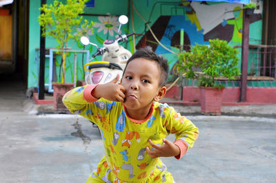 Portrait of cute child blowing bubbles at home