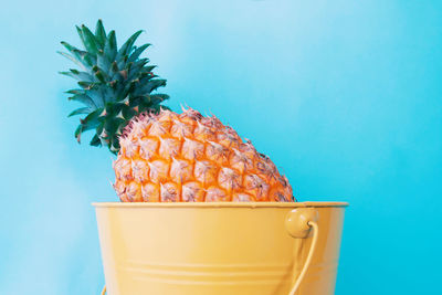 Close-up of orange juice against blue background