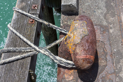 Close-up of rope tied up on wood