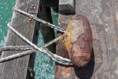 High angle view of rusty bollard during sunny day