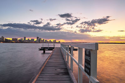 Pier on sea at sunset