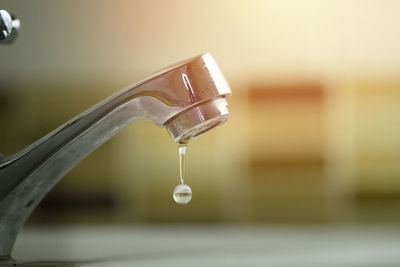 Close-up of water faucet in bathroom