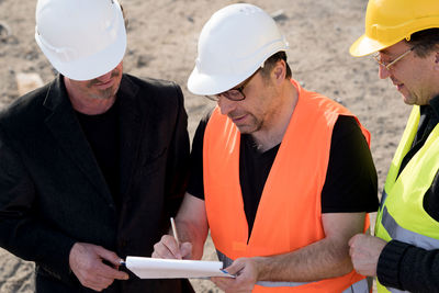 Construction workers communicating at site