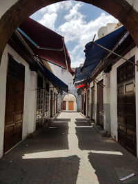 Cobblestone street amidst buildings against sky