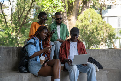 Meeting of peaceful african friends, classmates relaxing outside, having leisure time together.