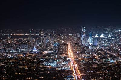 Illuminated cityscape against sky seen from twin peaks at night