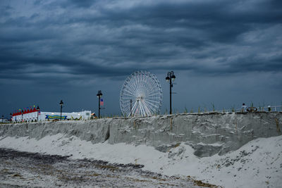 Cloudy sky above ferris wheel