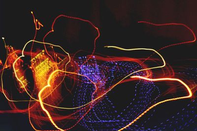 Light trails against black background