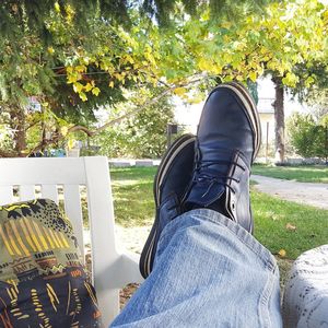 Low section of man sitting by plants