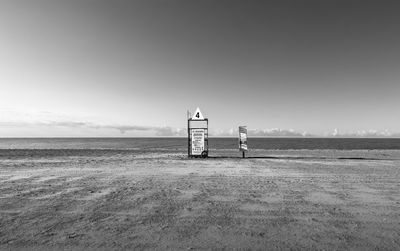 Lifeguard hut on land against clear sky