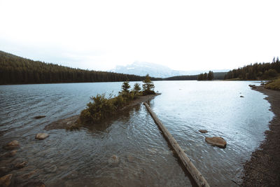 Scenic view of lake against sky during winter