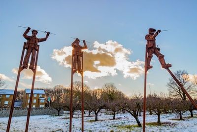 Low angle view of snow covered land on field against sky