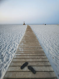 Pier over sea against clear sky