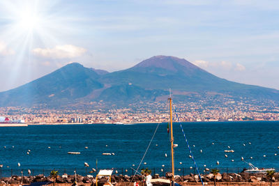 Scenic view of sea and mountains against sky