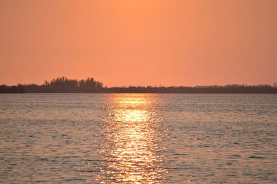 Scenic view of lake at sunset