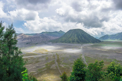 Scenic view of landscape and mountains against sky - mount bromo indonesia 