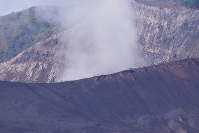 Smoke emitting from volcanic mountain against sky