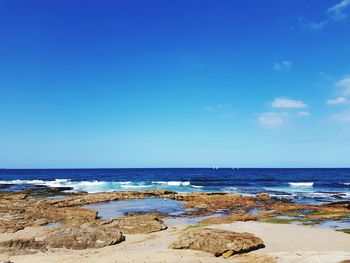 Scenic view of sea against blue sky