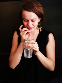 Close-up of young woman drinking glass